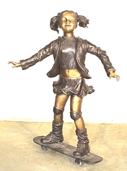 Bronze girl on a skateboard sculpture