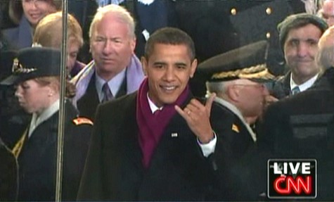 President Obama gives the hang loose sign.
